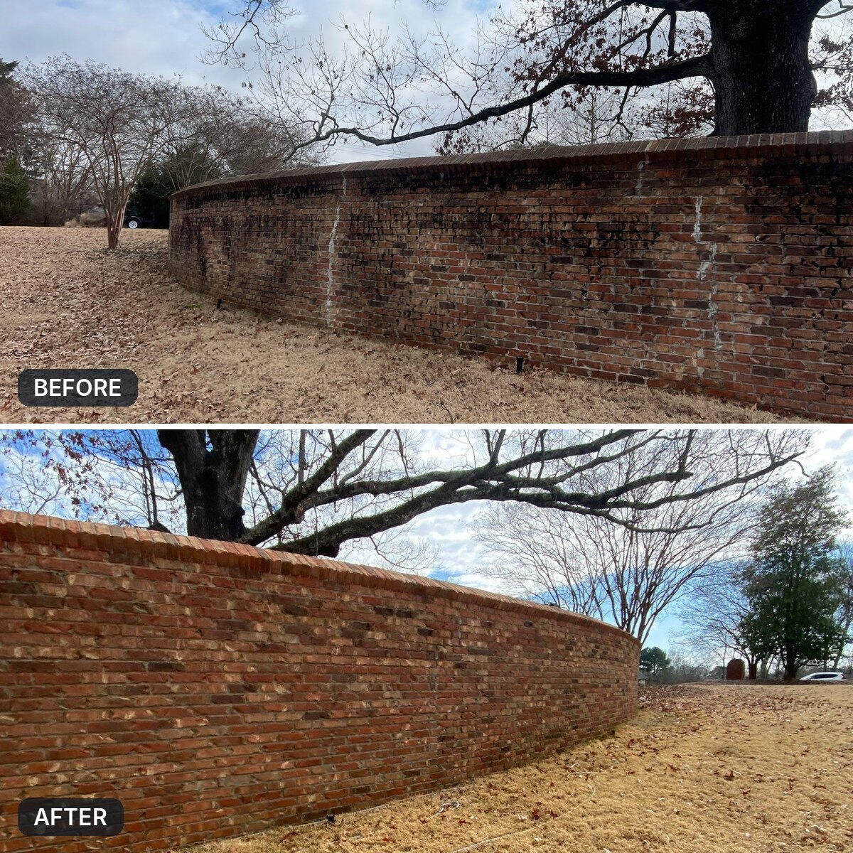 Before and after: a curved brick wall streaked with black mildew, pressure washed back to clean red brick in Ridgeland, MS.